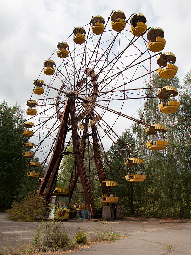 Rusted Ferris wheel with yellow gondolas at the Pripyat amusement park