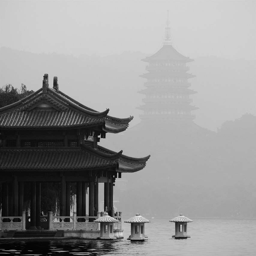 Traditional pavilion and Leifeng Pagoda in mist, West Lake Hangzhou