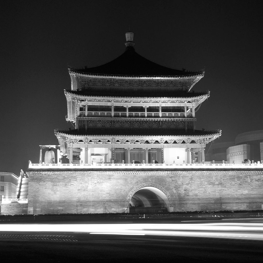 Xi'an Bell Tower illuminated at night with light trails