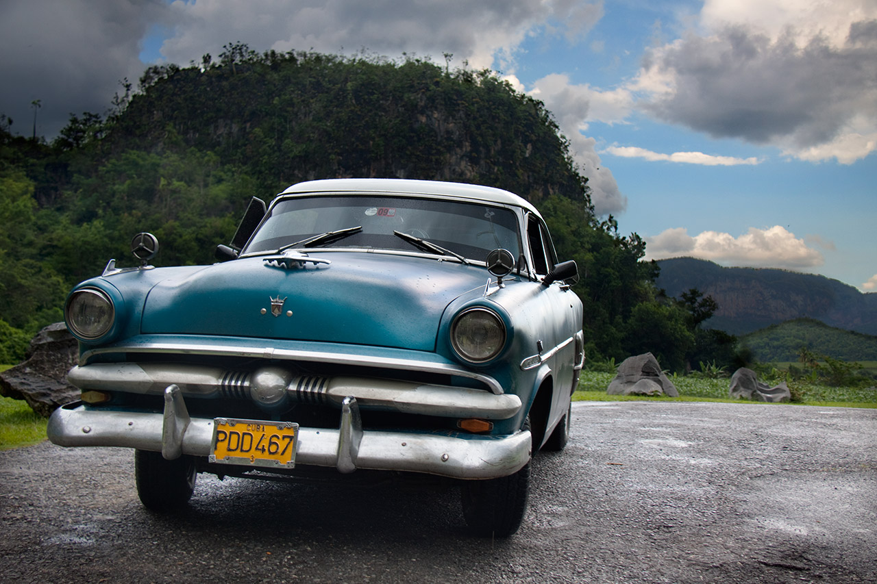 Turquoise classic American car parked in Viñales valley, Cuba