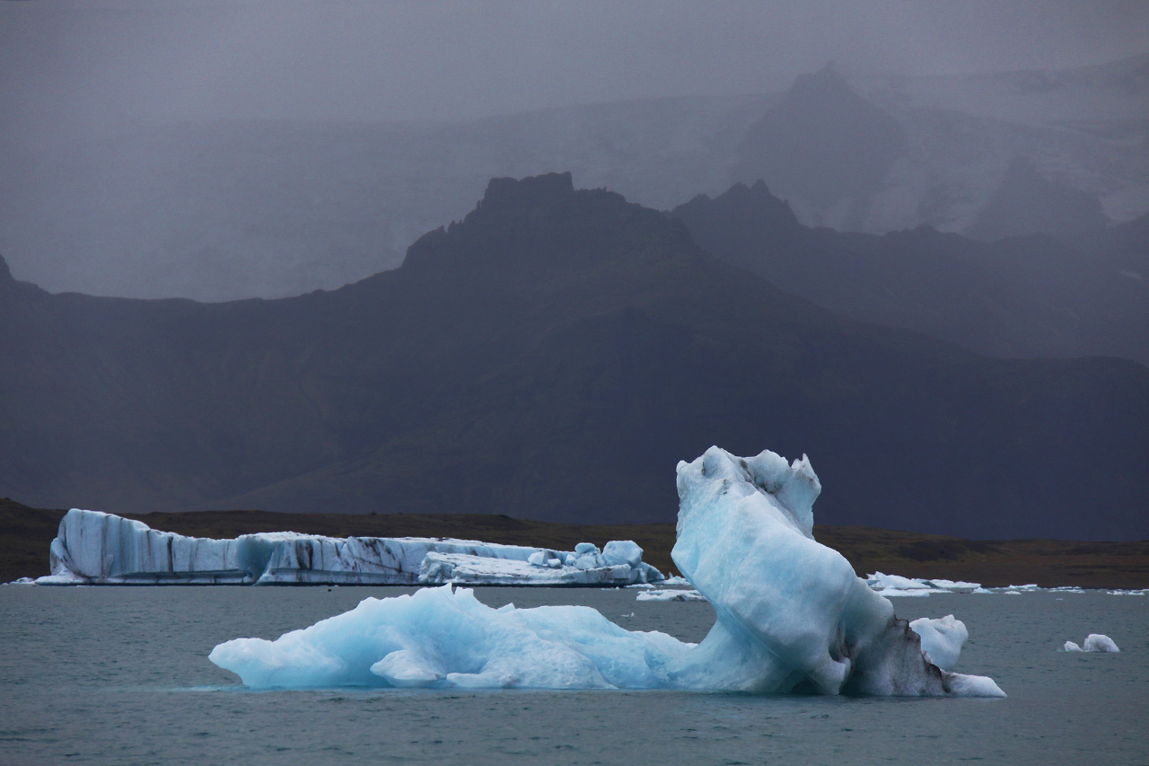 Icebergs at Jökulsárlón glacier lagoon with misty mountains