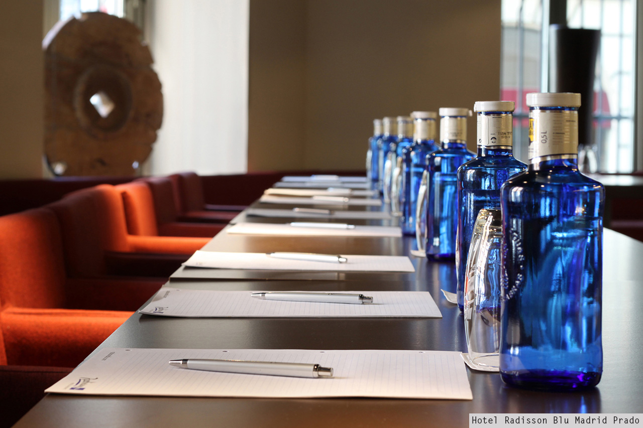 Hotel Radisson Blu Madrid Prado meeting room with blue water bottles