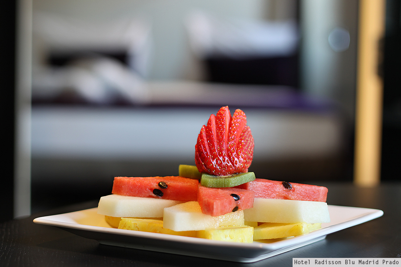 Fresh fruit plate with sculpted strawberry in a Hotel Radisson Blu Madrid Prado room
