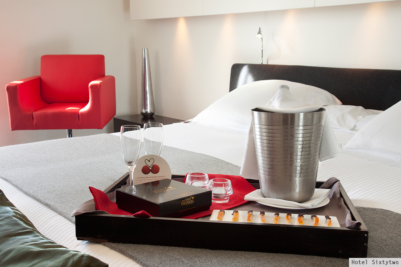 Hotel Sixtytwo room with champagne bucket, chocolates and red armchair