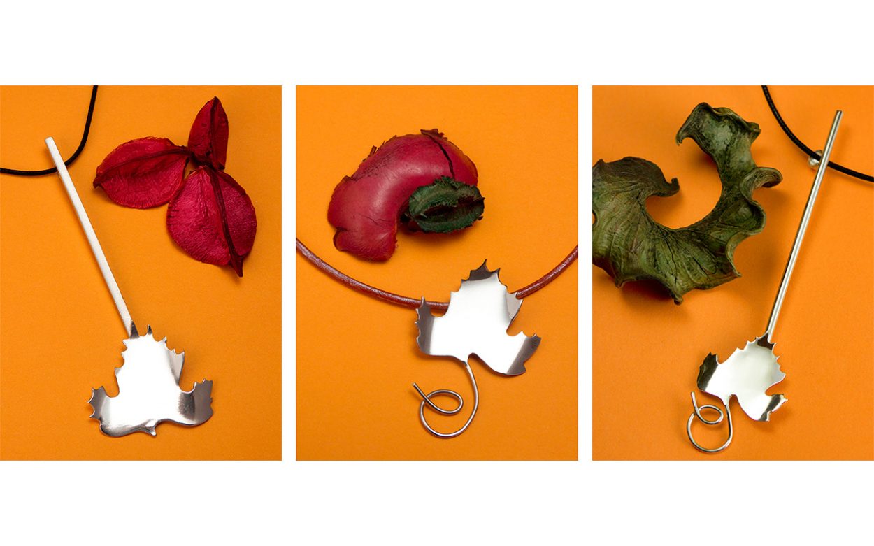 Silver leaf pendants on orange background
