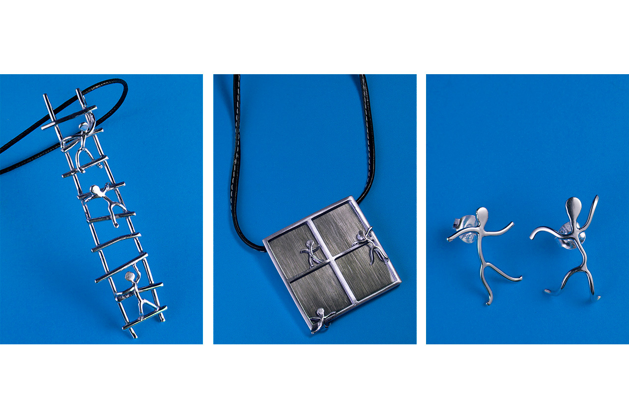 Silver figurine pendants on blue background