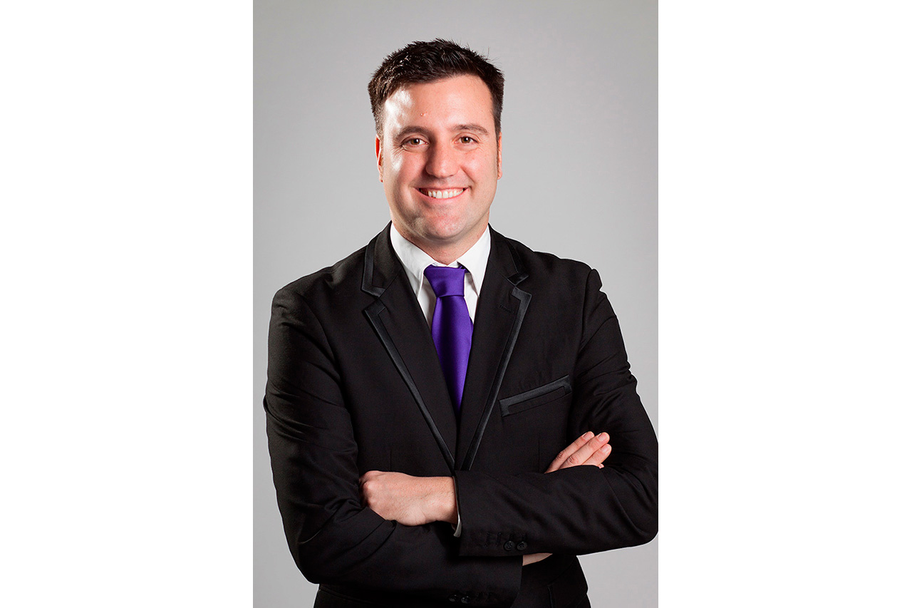 Studio portrait of man in suit with purple tie
