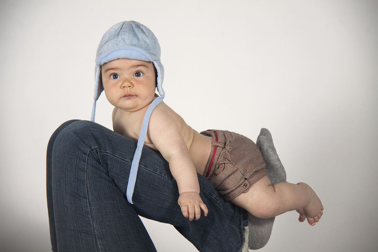 Baby with blue knit hat studio portrait