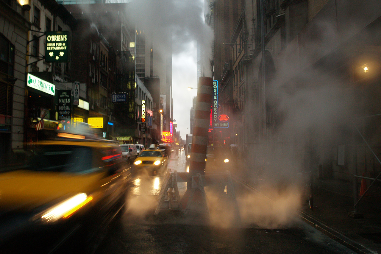 Yellow cab in steamy Times Square street, New York