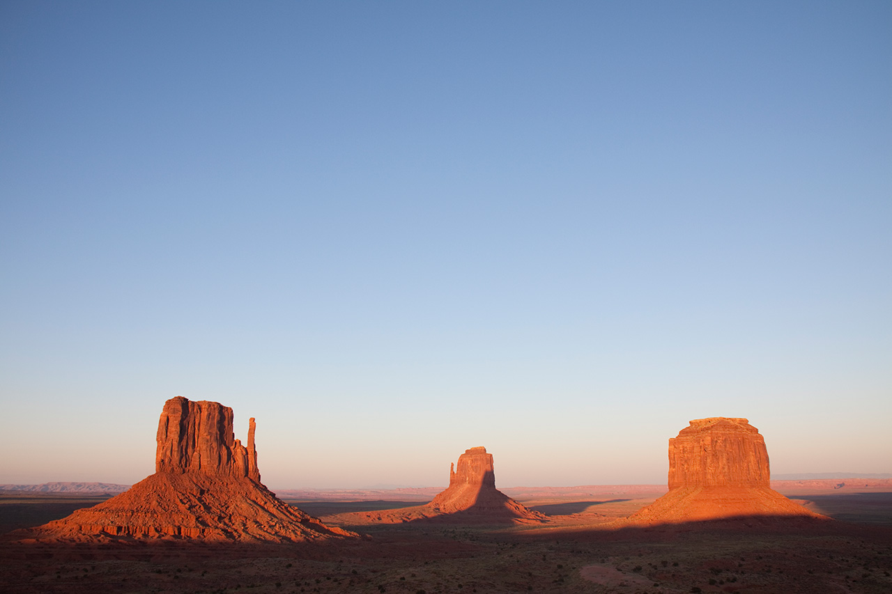Three buttes of Monument Valley at sunset