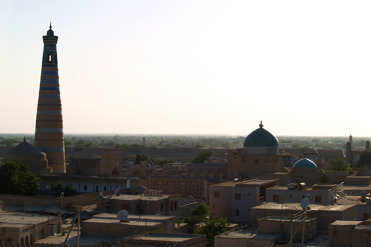Panoramic view over Khiva old town rooftops at dusk