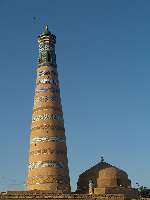 Islam Khoja minaret with bird at sunset, Khiva